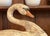 A vintage weathered folk art decorative decoy swan carving with textured patina, worn painted surface revealing layers of...