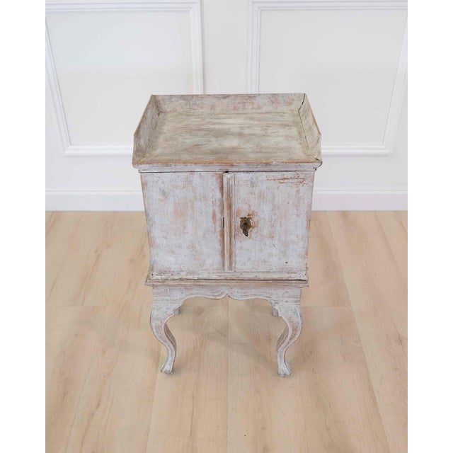 Charming 18th century Rococo nightstand featuring elegant proportions and graceful detailing characteristic of the period....
