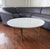 This is a round Carrara marble coffee table, produced in Italy in the 1960s. The stiletto legs are made of burnished...