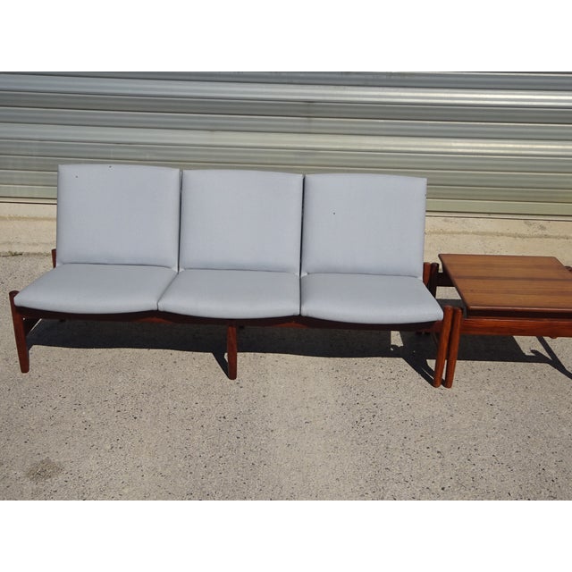 Teak lounge set comprising a three-seater sofa and a modular coffee table. Model Saga, Norwegian manufacture, 1960s, by...