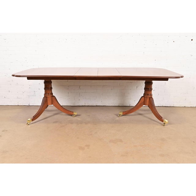 An exceptional Georgian or Regency style double pedestal extension dining table In the manner of Henkel Harris USA, Circa...