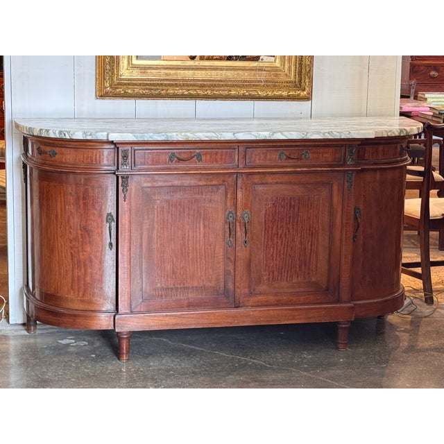 A substantial French mahogany server with a shaped white marble top with green veining. The case has two drawers across...