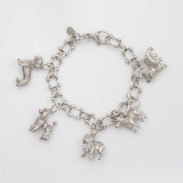 Stylish vintage Tiffany & Co dog themed charm bracelet crafted in sterling silver (circa 1980s). A hard to find and...