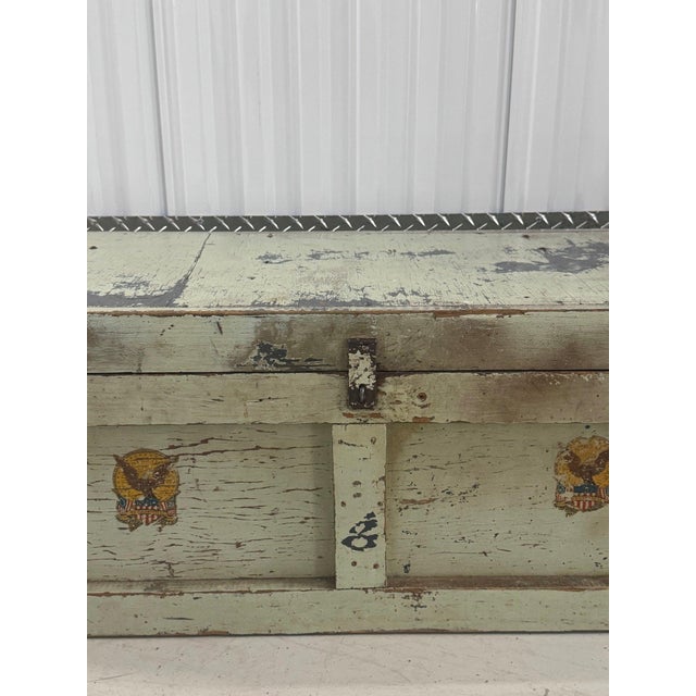 A flat-top wood trunk, circa 1940s, in its original sage green over off-white paint, crackled and chipped down to bare...