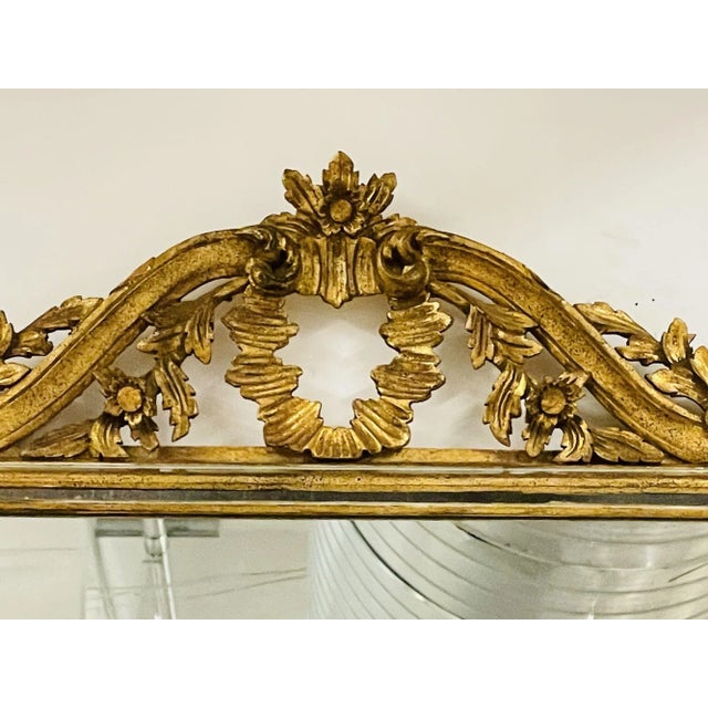 Italian Wall, Console or Pier Mirror. 1930s. Gilt Gold, Carved A center mirror flanked by gilt wooden sides having a...
