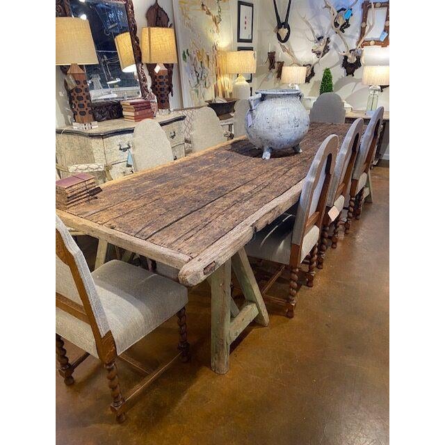 French farm table found in Provence. Saw horse leg base with weathered reclaimed wood top. 131”l x 40”d x 32”h 41-024