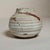 This hand-thrown studio pottery vessel features a softly rounded, bulbous form with pronounced horizontal ribbing that...