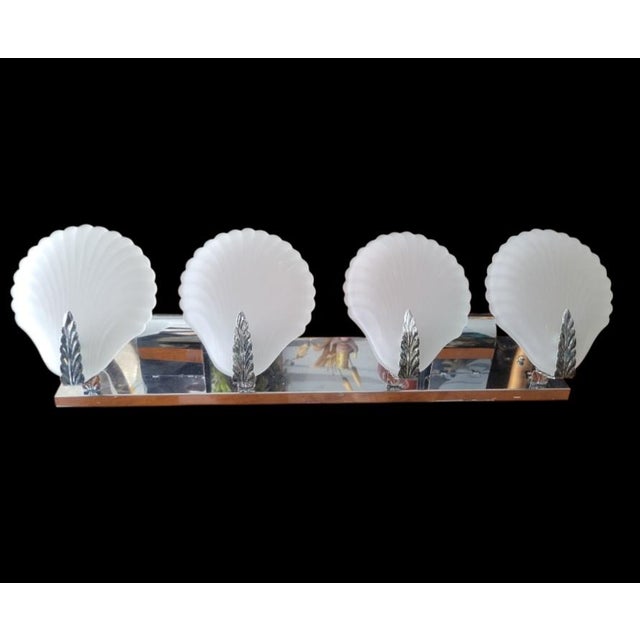 ​Bring coastal glamour and vintage sophistication to your powder room or bath with this stunning four-light vanity sconce....