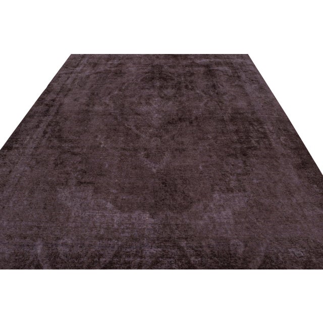 From our new collection of overdyed rugs, a vintage 9x12 Persian rug originating circa 1970-1980 or possibly earlier. On...