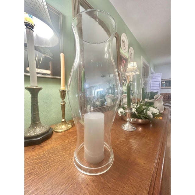 This large blown glass candle hurricane was created in Milton, West Virginia, between 1937 and the late 20th century....