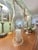 This large blown glass candle hurricane was created in Milton, West Virginia, between 1937 and the late 20th century....