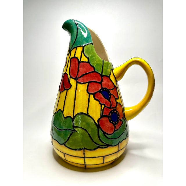 The exquisite shape of this large, yet light weight pitcher is hand-crafted mimicking the Tiffany style of stained glass...