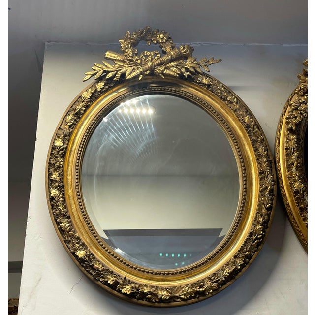 Bring timeless European elegance to your home with this charming oval wall mirror, featuring an ornate gold leaf frame...