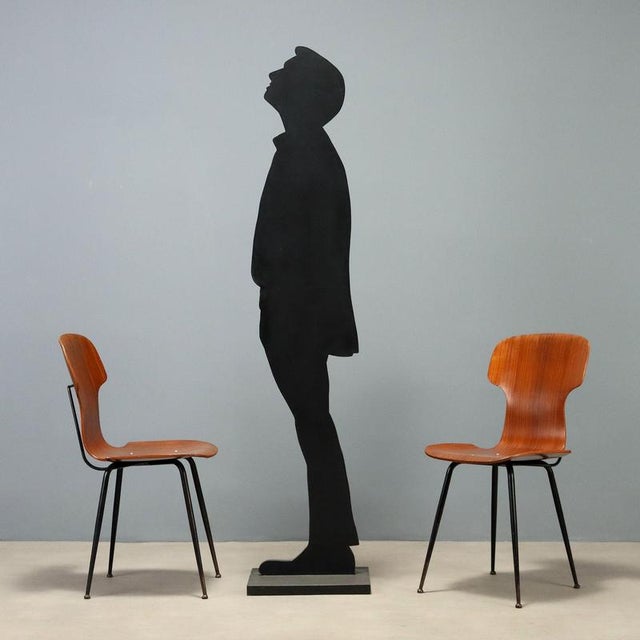Six 1960s chairs with a distinctive design featuring seats made of bent plywood, a material that combines elegance and...