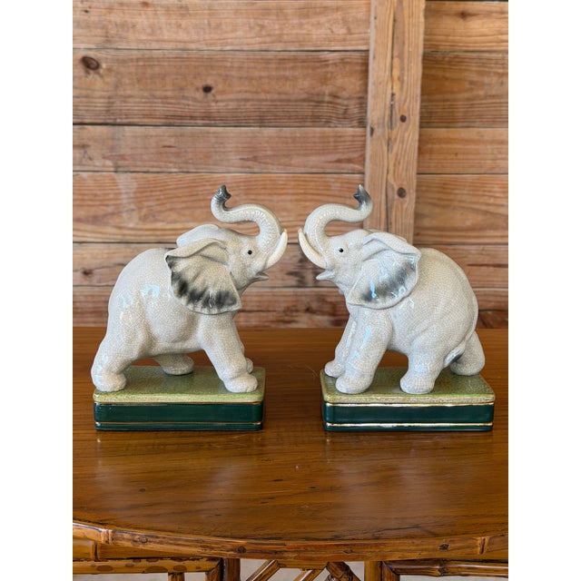 A charming pair of ceramic elephant bookends by Takahashi, made in Japan. Each elephant features an upturned trunk,...