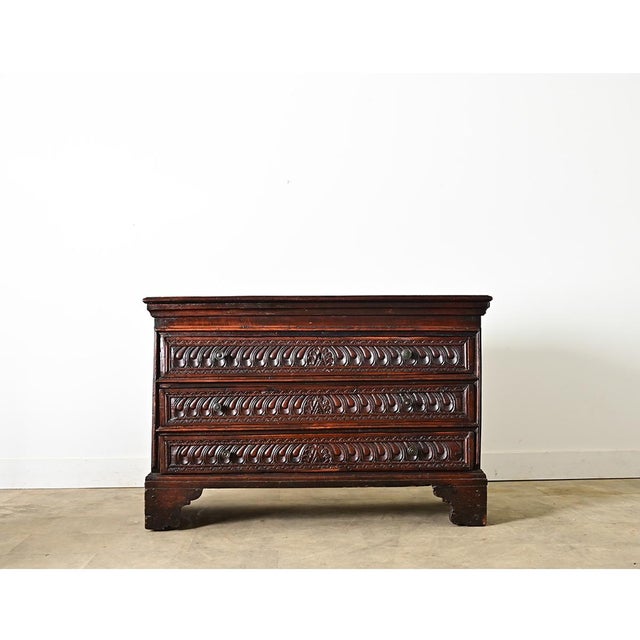 A striking Italian commode/chest of drawers from circa 1850, all hand-crafted from cedar that has taken on a deep mahogany...