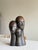 A striking 1970s modernist ceramic sculpture featuring three elongated heads rising from a shared base. The faces are...