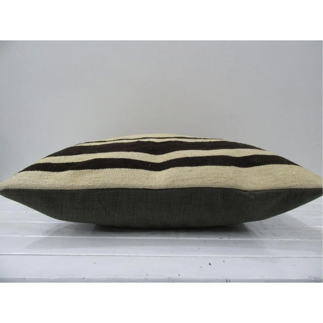 This is a pillow cover made from a vintage kilim rug. The piece was properly washed and ready to use. Pillow inserts not...