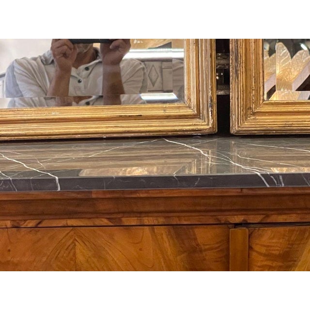 This product is a pair of antique French transitional giltwood mirrors, perfect for those seeking to add a touch of...