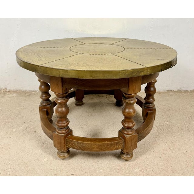 A charming small Spanish center table crafted from solid wood during the mid-20th century. The table features a...