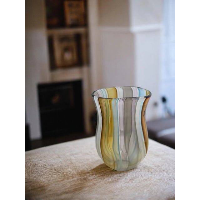 Add a touch of elegance to your space with our tiki colored vase. This hand-blown glass vase features soft, beach-inspired...