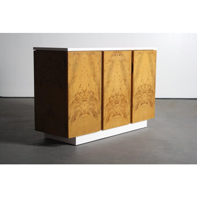 Petite burl wood 2-tone credenza/buffet in the manner of Milo Baughman. The cabinet faces and sides are finished with a...