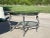 modern classic with a sculptural twist — this round center table features a cast steel base with four stylized horse...