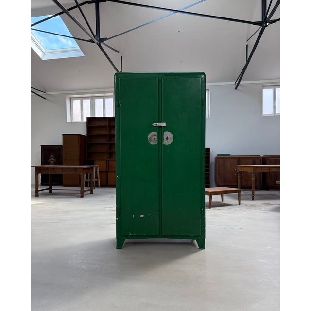 This vintage metal cabinet, with its industrial look, is both practical and stylish. It opens with two hinged doors, each...