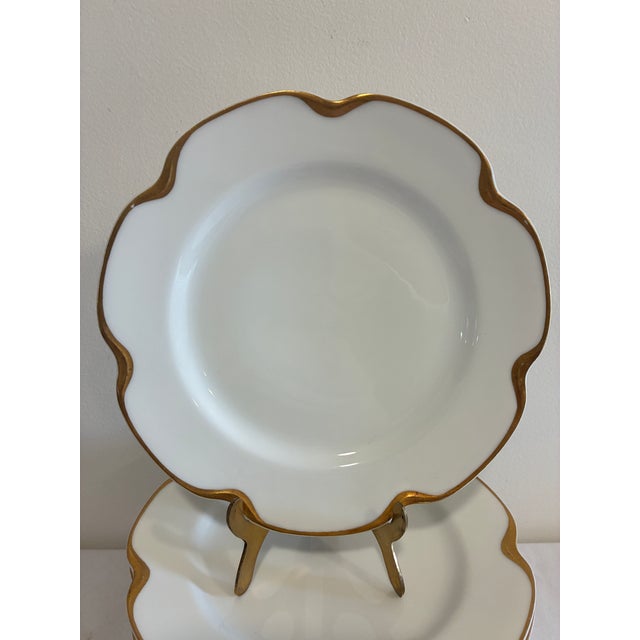 An elegant set of 11 antique Haviland & Co. Limoges porcelain plates, each with a graceful wavy scalloped edge finished in...