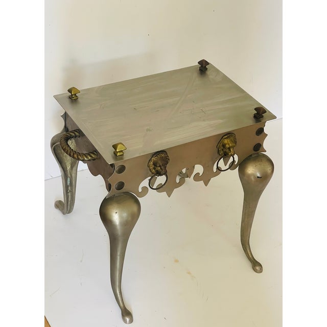 Unique design by Classic Workshops NY - stainless steel small side table decorated with brass handles and lion heads,