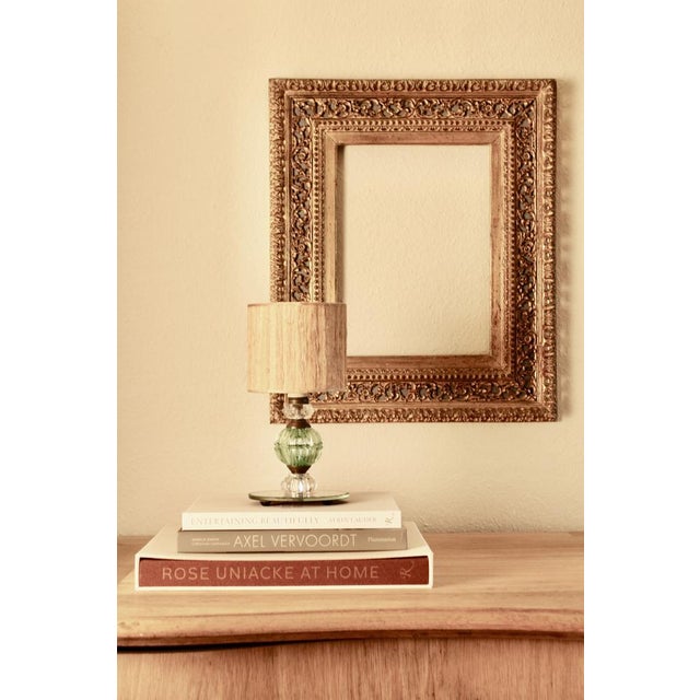 An exquisite French Art Deco table lamp from the 1920s–1930s, featuring a mirrored oval base adorned with cut glass beads....