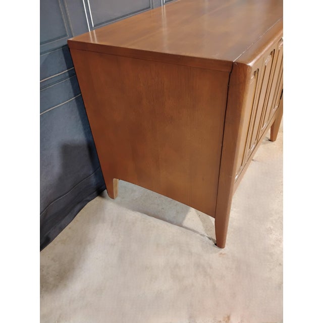 A Mid Century Nightstand from Broyhill Furniture. This is from Broyhill's 'Emphasis' line. It is walnut and has been...
