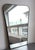 Mid-century italian wall mirror with brass frame (circa 1960s). The mirror is classically-shaped and certainly modern in...