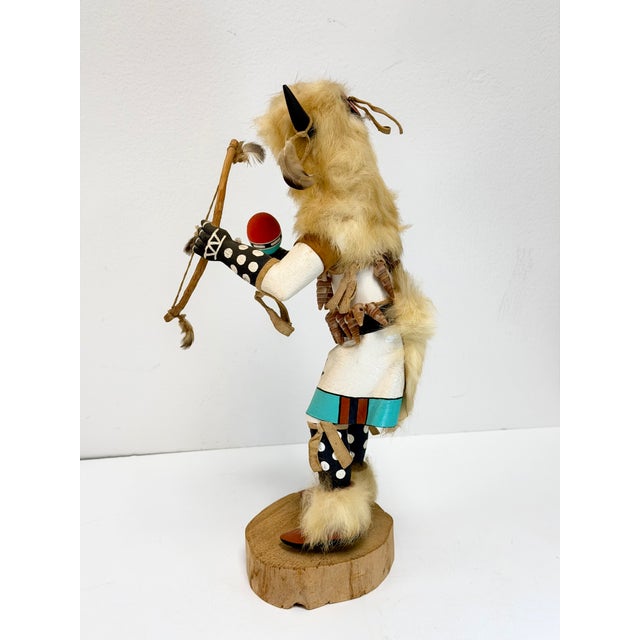 Beautifully hand-carved White Buffalo Kachina doll, featuring fur accents, a feathered bow, painted leather skirt, tiny...