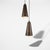 Two slender conical pendants, each holding at its tip a faceted cut-crystal diffuser by Fontana Arte. The cone, in...