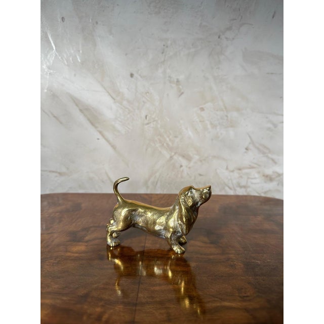 A charming decorative sculpture of a Basset Hound, crafted in brass and dating from the 1960s. This piece is distinguished...