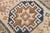 This hand-knotted Caucasian Kazak runner features bold geometric medallions in earthy and navy tones. A timeless piece to...