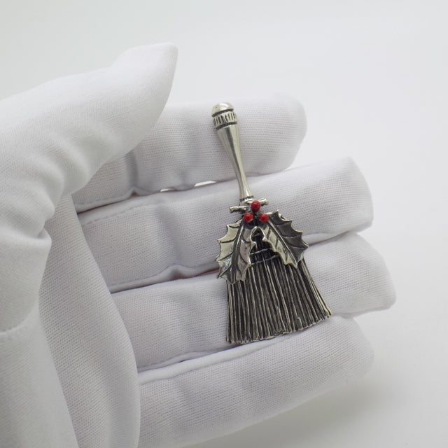 A vintage object depicting a traditional “scopetta spazzaguai” (good-luck broom) with a decorative butcher’s broom...