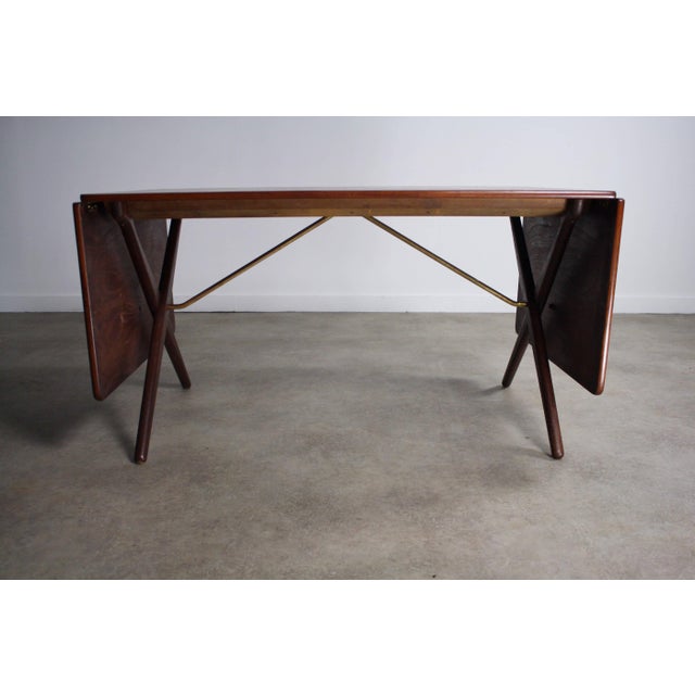 This iconic period piece is coveted and highly collectable. The Hans Wegner Model AT-309 drop leaf extension table was...