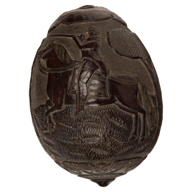This rare early 19th-century French Colonial carved coconut "bugbear" flask is a fascinating artifact showcasing the...