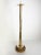 French floor candle holder dating from the 1970s, crafted from brass and rattan. Its tall, slender structure evokes a...