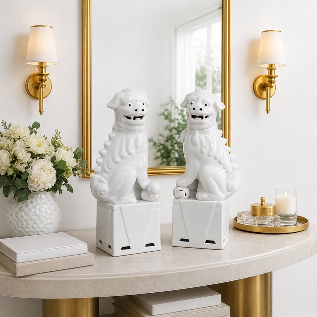 A striking pair of Chinese blanc de chine guardian lions rendered in luminous white porcelain and presented in the...