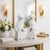 A striking pair of Chinese blanc de chine guardian lions rendered in luminous white porcelain and presented in the...