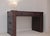 The Steamer Trunk Desk has a handmade solid wood frame wrapped in Vintage Cigar leather accented with up to 3,000 hand-...