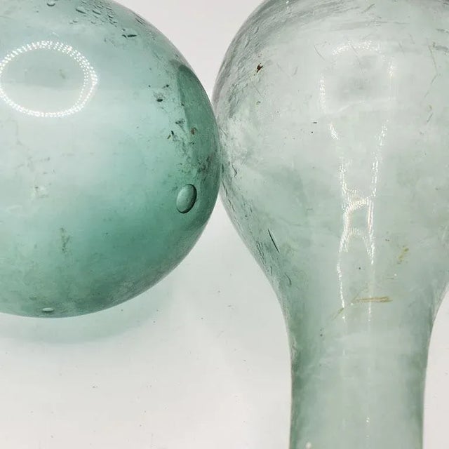 Dredged from the Panama Canal, this set of two blue glass bottles will be a beautiful addition to any glass collectors...