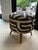 Pair of authentic African Ottomans with three carved accent legs. Each ottoman features a solid internal wooden framework...