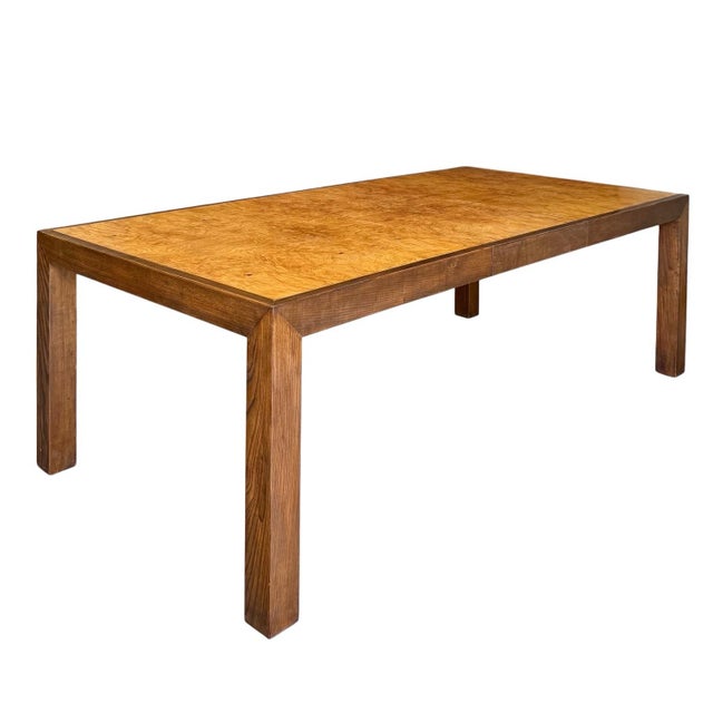 An elegant Modernist Parsons dining table crafted in oak with a warm walnut finish, featuring a striking top composed of...