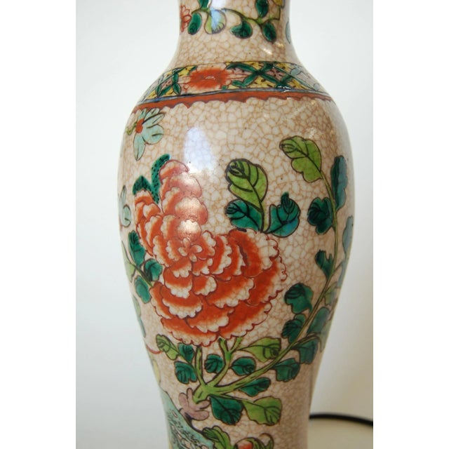 Asian hand painted floral ceramic table lamp on a metal base. Measures 4.5" W x 4.5" D x 17" Tall.