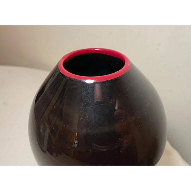 Up for sale is a wonderful hand blown studio art glass vase. It is blown into a gorgeous silhouette out of a dark black...