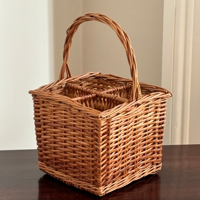 Offering a lovely French-style wicker wine caddy from the mid-20th century. Beautifully handwoven, this basket features...